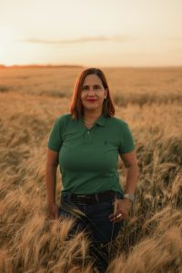 Plant Breeder Enid Perez-Lara, PhD in a field