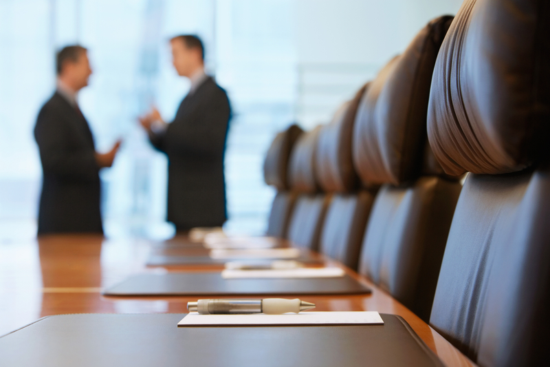 Businessmen Talking In Conference Room